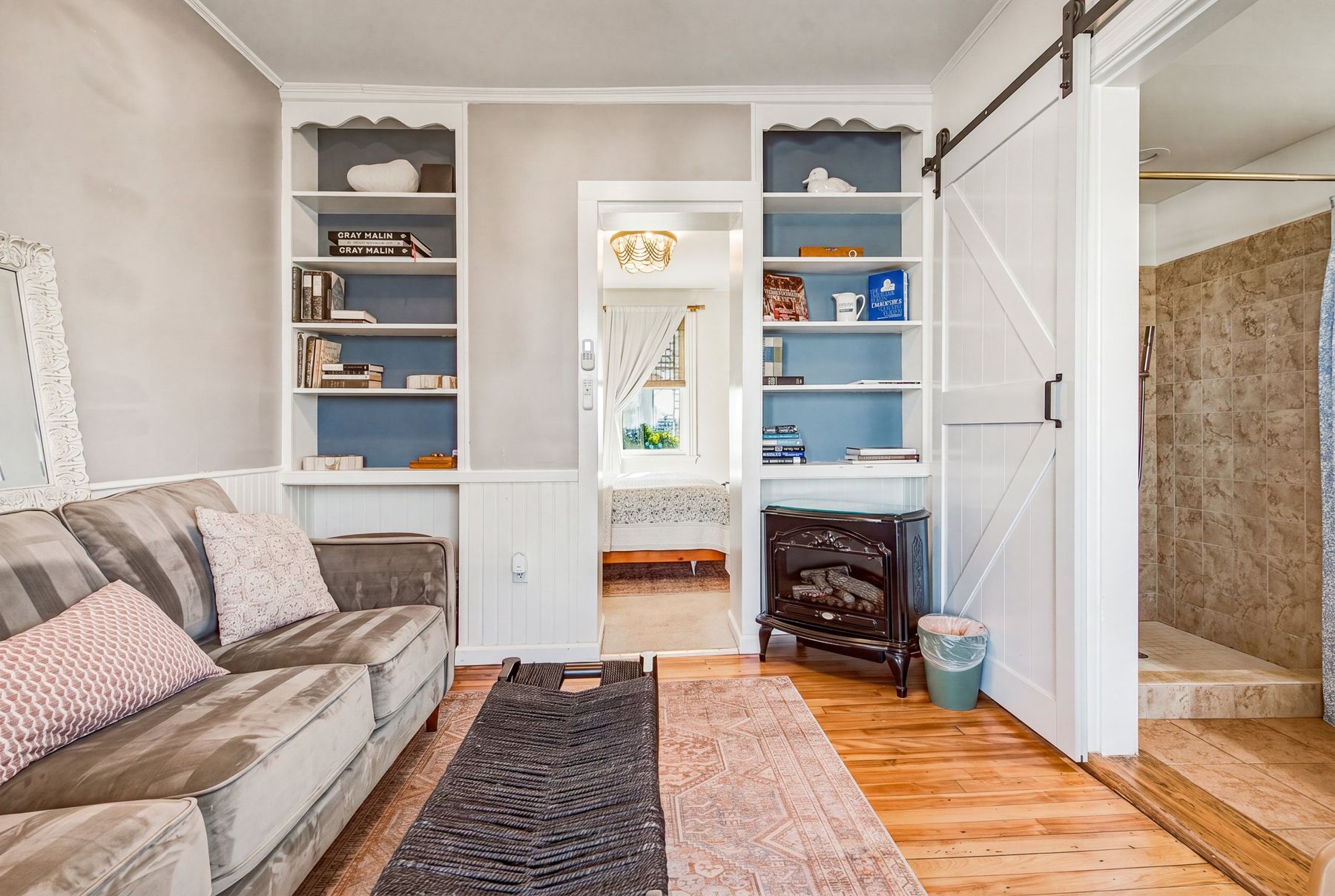 Built-in bookshelves and the gas stove in the sitting room