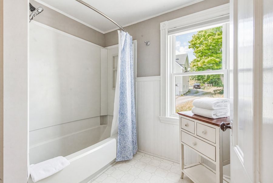 Bathroom with tub and window
