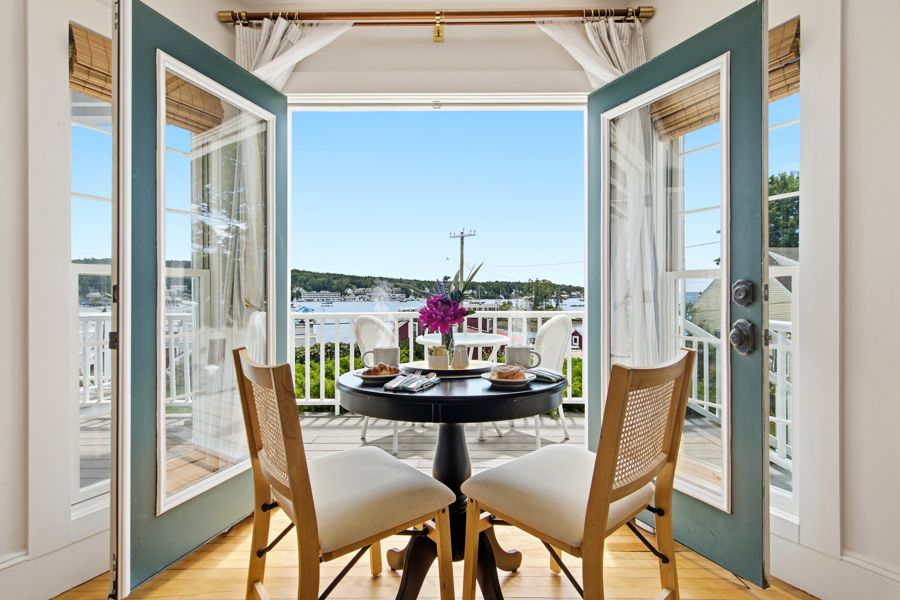 French doors to the balcony table over the harbor