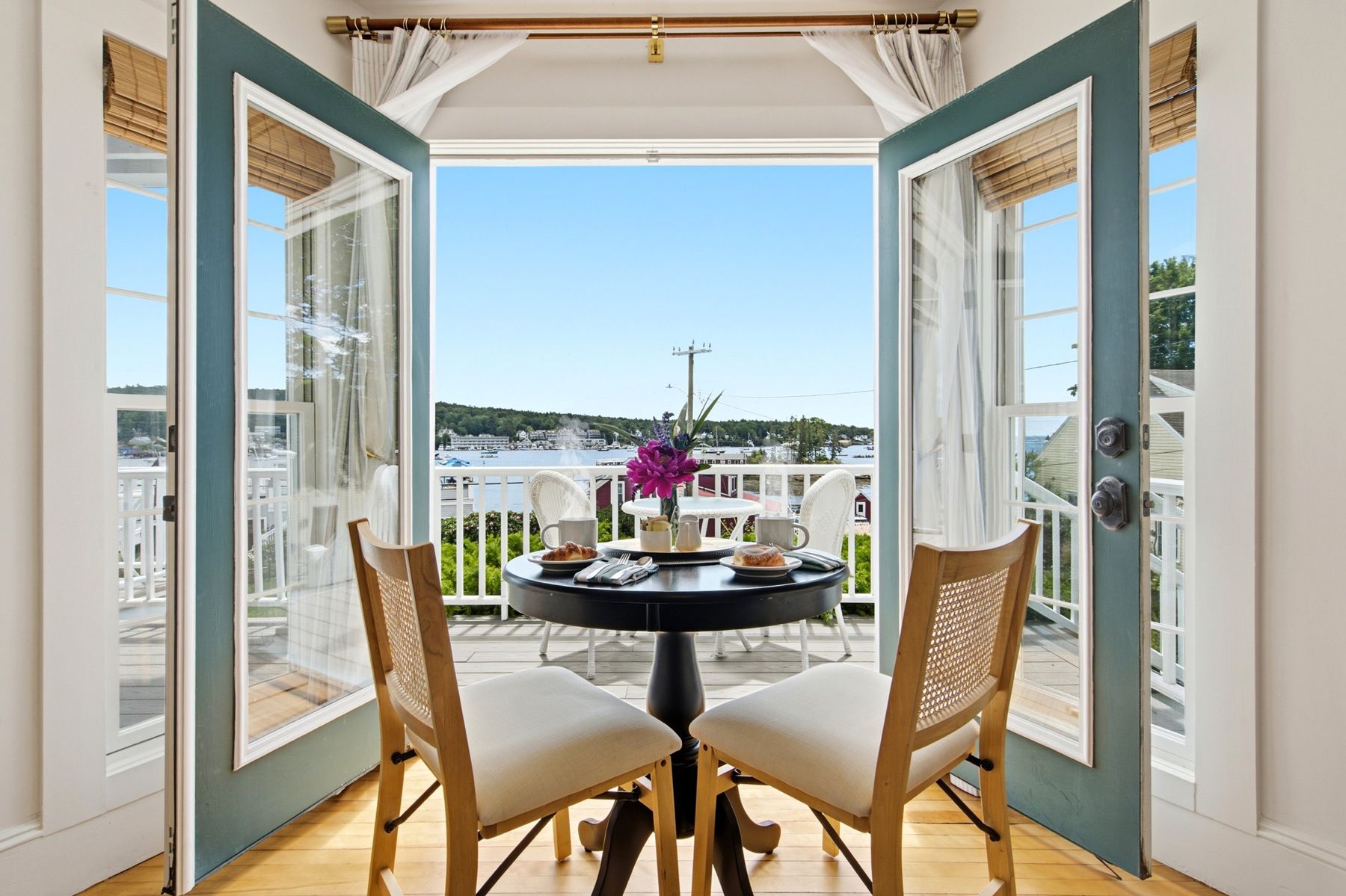 French doors to the balcony table over the harbor